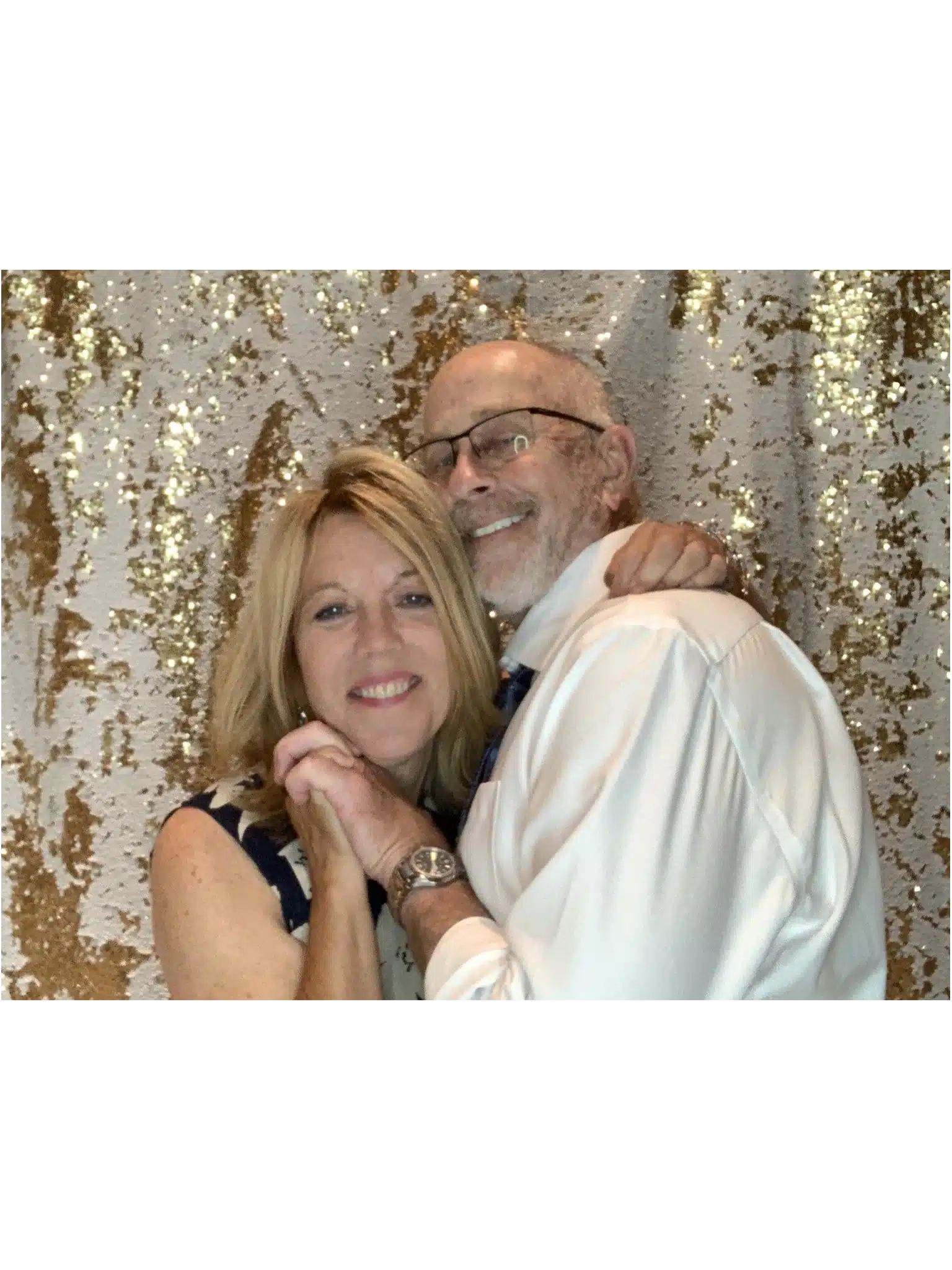 Couple sharing a tender moment in front of a sparkling gold backdrop at Fastbooth photobooth Grand Rapids, MI
