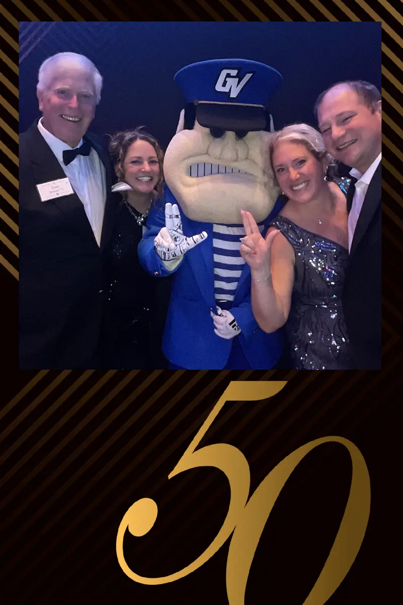 Guests posing with Grand Valley State University mascot in FastBooth photo booth at 50th anniversary gala