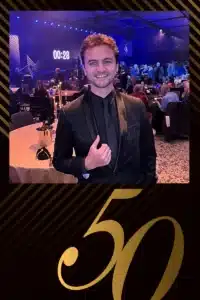 Guest in formal attire at 50th anniversary corporate gala ballroom captured by FastBooth photo booth