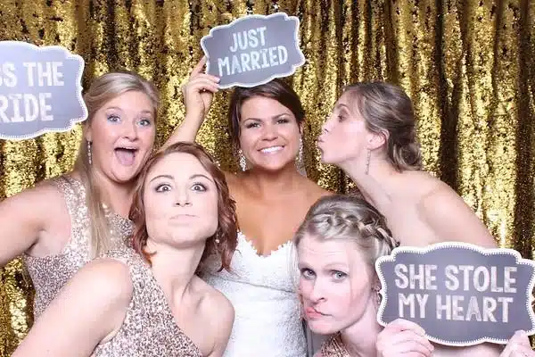 Bridal party posing with Just Married props in a FastBooth photo booth