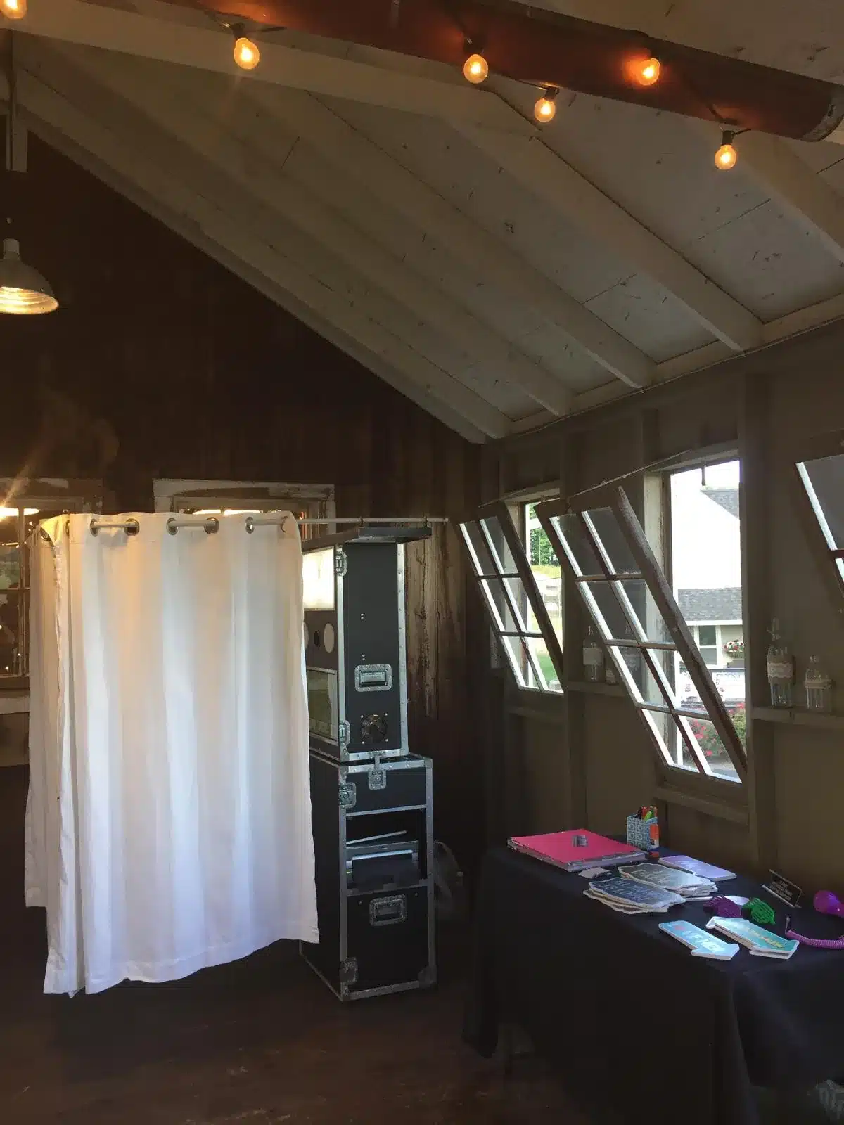 FastBooth enclosed photo booth with white curtains at a wedding reception