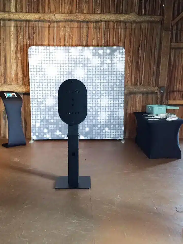 FastBooth photo booth with silver sequin backdrop at a barn venue
